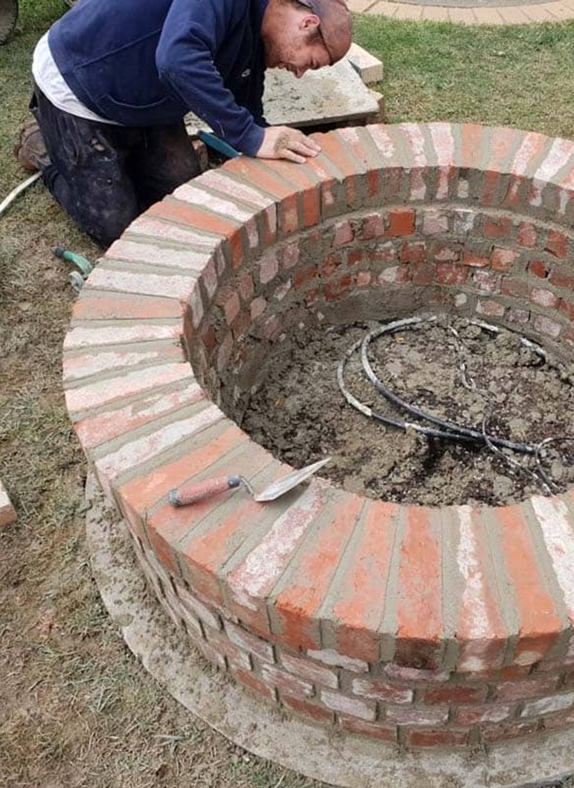 Circular brick planter or fire pit with radial header course brickwork